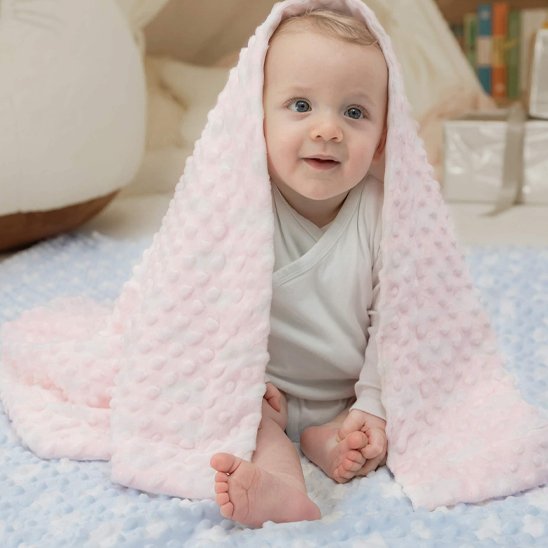 Bébé garçon avec couverture rose douce